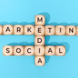 Social Media Marketing words on wooden blocks on blue background. Top view